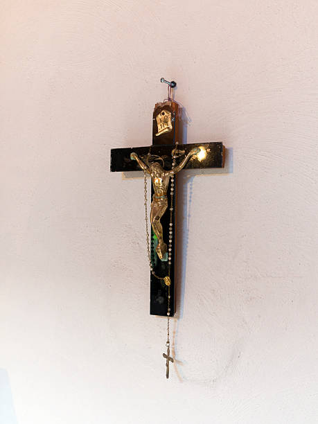 istock Crucifix cross and rosary on white wall 496310997