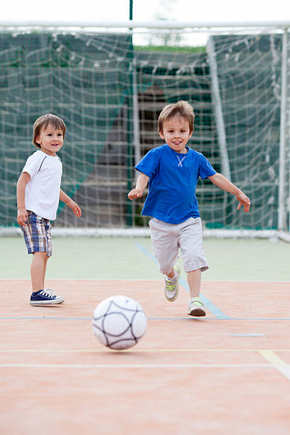 istock Two little boy, playing football 496311317