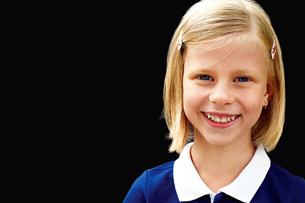 istock school child standing at chalkboard and looking at camera 496311493