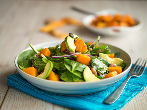freshness roasted pumpkin salad with spinach,red onion and avocado,add pumpkin seeds.