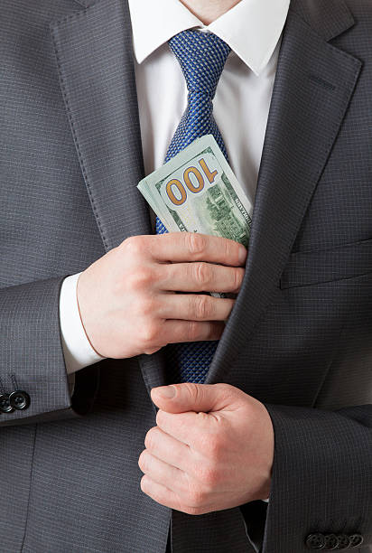istock Businessman holding dollars/putting dollars in a pocket 496312672
