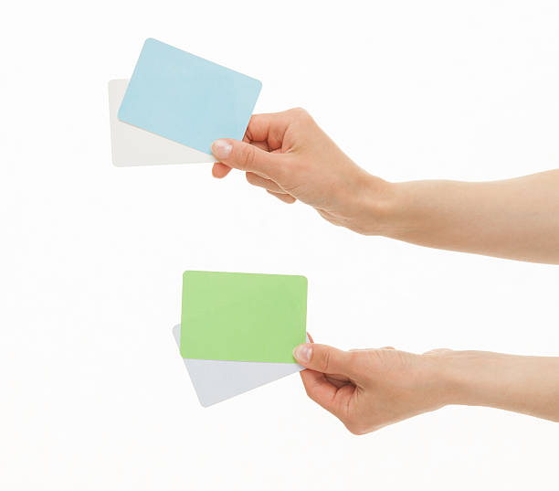 istock Two hands holding colorful paper cards 496314844