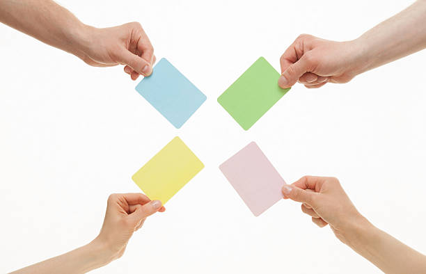 istock Human hands holding colorful paper cards 496314898