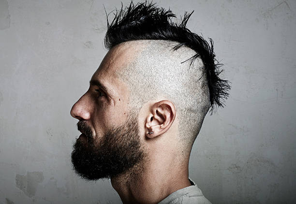 istock Portrait of a bearded man with mohawk. Concrete background 496317550