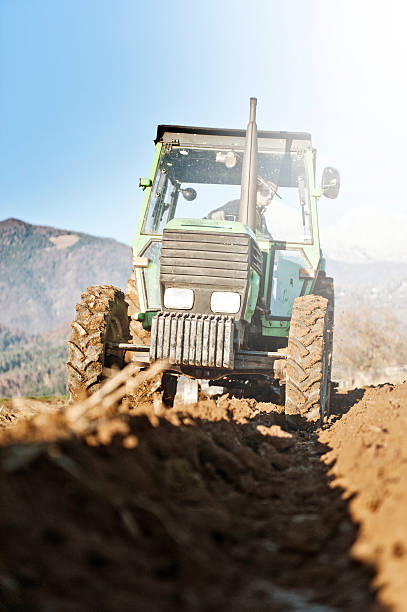 istock Ploughing on the field in sunlight 496319750