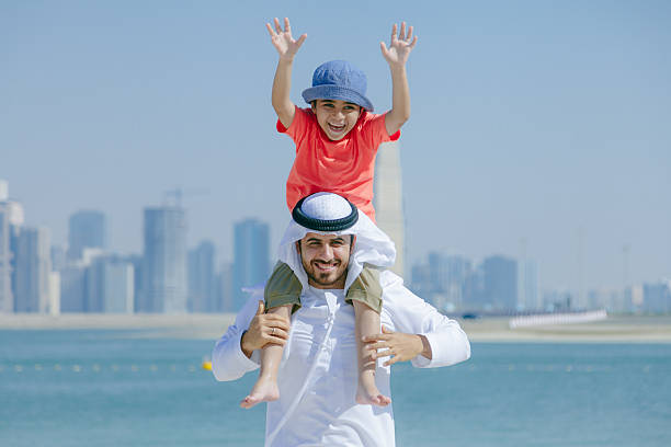 istock Arab father and son having fun at beach 496321788