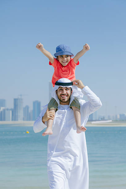 istock Arab father and son having fun at beach 496321912