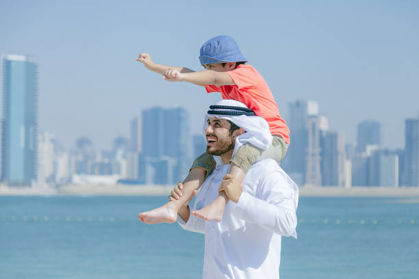 istock Arab father and son having fun at beach 496322088