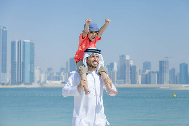 istock Arab father and son having fun at beach 496322144