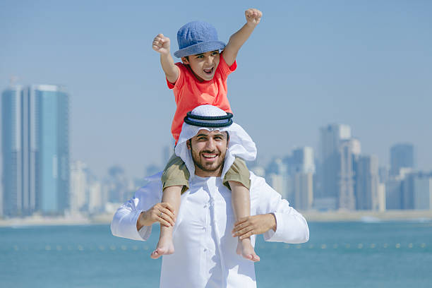 istock Arab father and son having fun at beach 496322216
