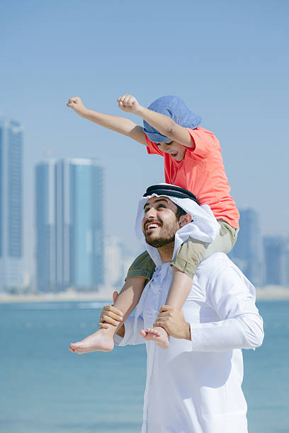 istock Arab father and son having fun at beach 496322276