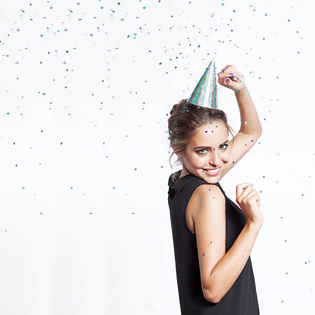 istock Woman in a festive cap dancing and smiling 496346786