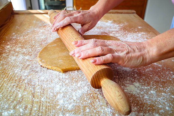 istock Woman hand kneading dough with rolling pin 496348180