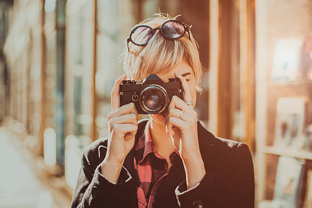 istock Beautiful young woman with photo camera 496348330