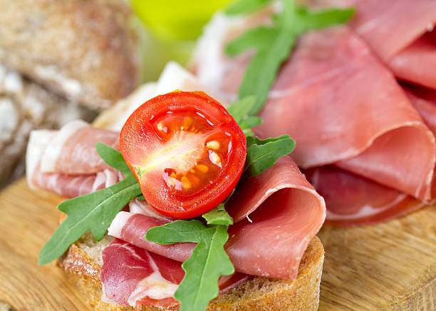 istock bread with sliced prosciutto crudo 496348360