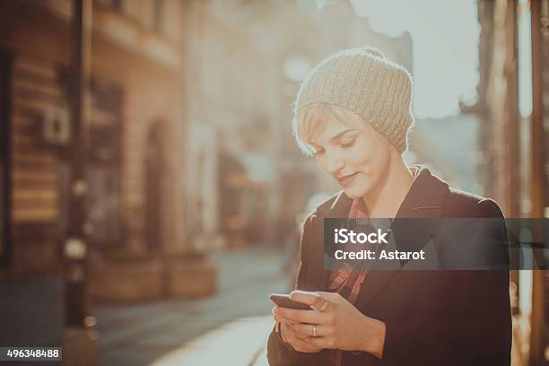 Young Woman Using Her Mobile Phone Stock Photo - Download Image Now - Mobile Phone, Autumn, Telephone