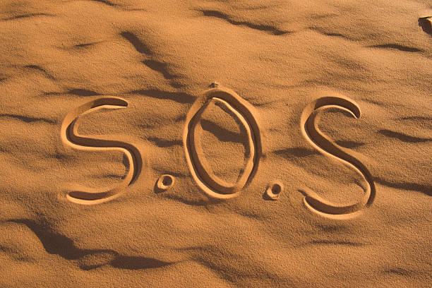 istock S.O.S Sign on the beach 496348490