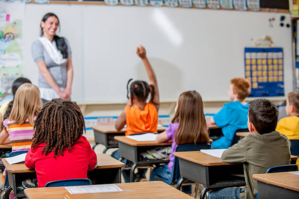 istock Little Girl Answering an Assignment on the Board 496348520