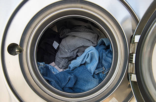 Laundry machine Laundry machine at work tumble dryer stock pictures, royalty-free photos & images