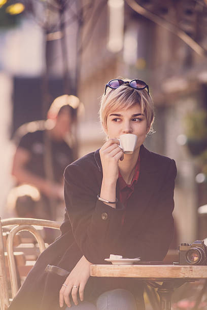istock Young beautiful woman drinking coffe at cafe 496348648