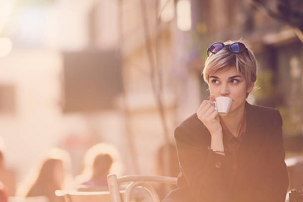 istock Young beautiful woman drinking coffe at cafee 496348774