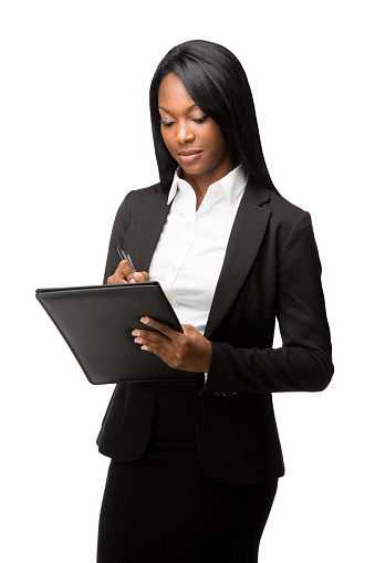 A beautiful afro-american business woman writing on a folder. Isolated on a white background.