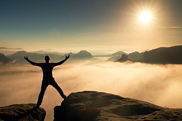 istock Funny jumping hiker celebrate triumph. Stay between two peaks 496349036