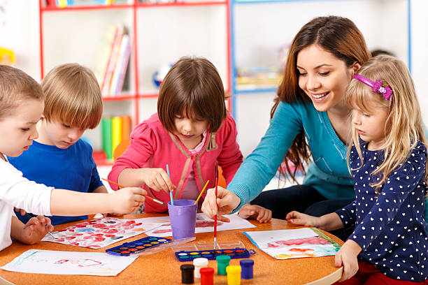 istock Group Of Elementary Age Children In Art Class With Teacher 496349105