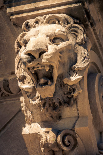 A lion sculpture on the outside of a building