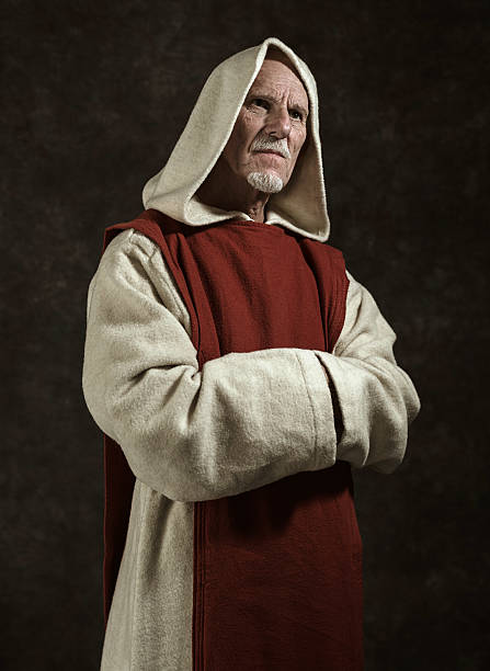 Official portrait of monastic. Studio shot against dark wall.