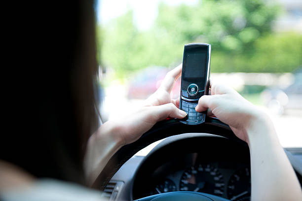istock Teenager on her Phone While Driving 496350358