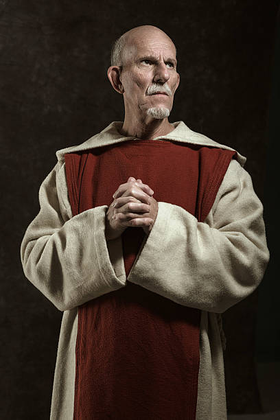 istock Official portrait of monastic. Studio shot against dark wall. 496350772