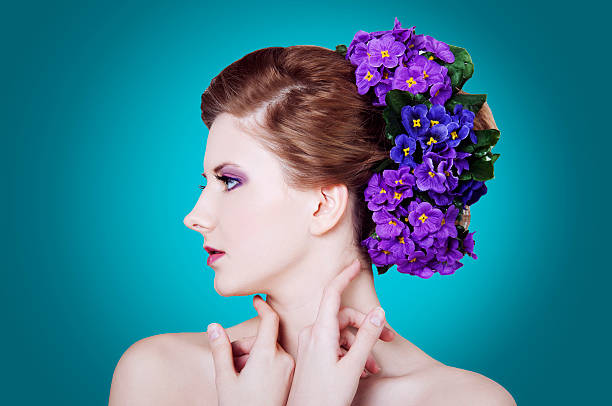 istock Woman with viola flowers  on a turquoise background 496350841