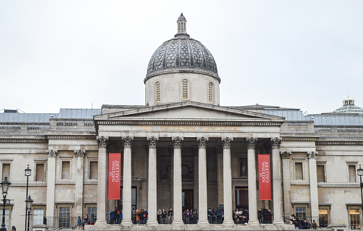 London, UK - March 21, 2015: The National Gallery in Trafalgar Square in central London. Photo taken during an overcast day and contains many people visiting the museum.