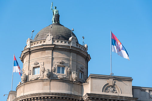 Belgrade, Serbia - October 24, 2015: The dome of the Serbian Government building with two Serbian flags. Government building is located in Kneza Milosa street in Belgrade downtown.