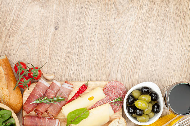 istock Red wine with cheese, olives, tomatoes, prosciutto, bread and spices 496352535