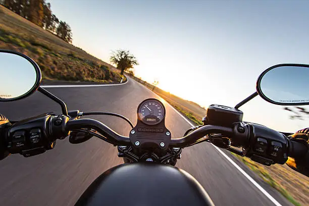 The view over the handlebars of motorcycle. Travel theme.
