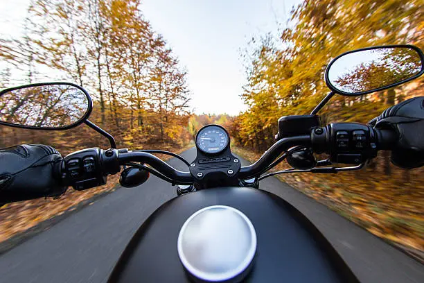 The view over the handlebars of motorcycle. Travel theme.