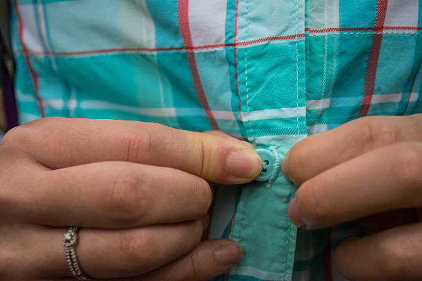 Button 3 Girl Buttoning Shirt women shirt button stock pictures, royalty-free photos & images