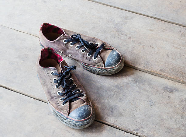 istock Dirty old shoes on the floor 496357456