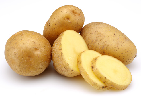 raw potatoes and slices isolated on white background