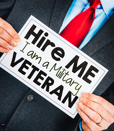 Businessman holding veteran sign