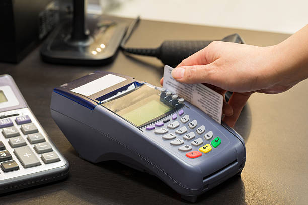 istock Hand Swiping Credit Card In Store 496377688