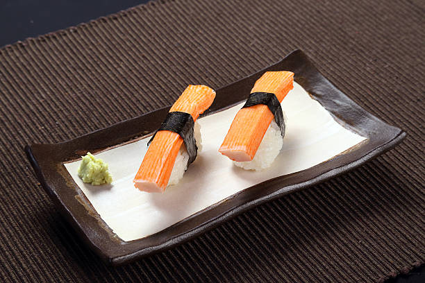 istock Crab stick sushi with wasabi on ceramic dish 496378496