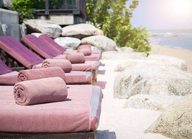 istock empty sunbed with wrapped towels on a beautiful beach 496382844