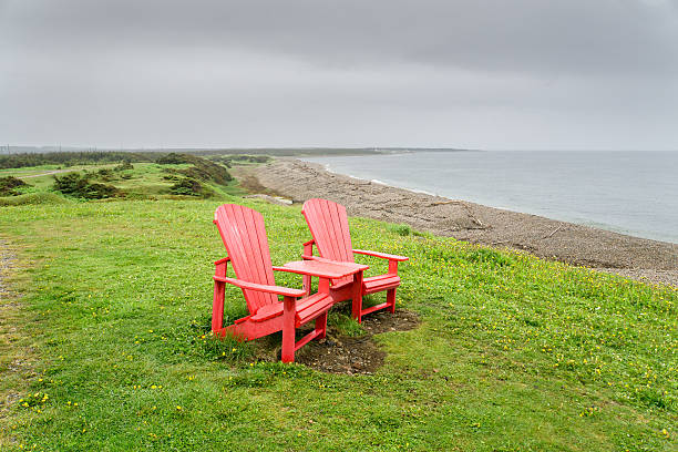 istock Newfoundland Red Chairs on the Beach 496383586