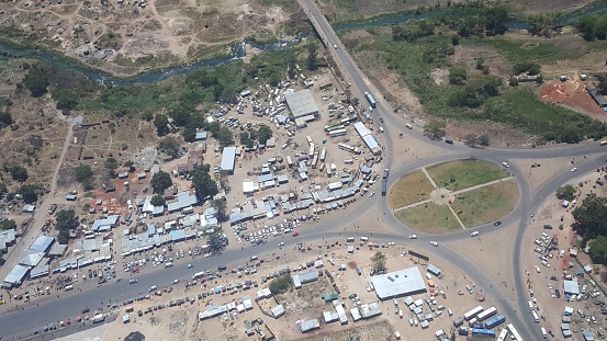 Intersection in Harare, Zimbabwe. Corner High Glen road & Simon Mazorodze road. Rural area with street markets and transport systems.