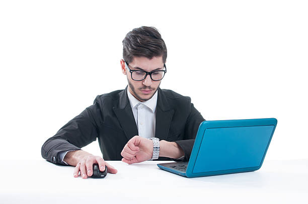 istock Businessman sitting at office while looking at his watch 496384676