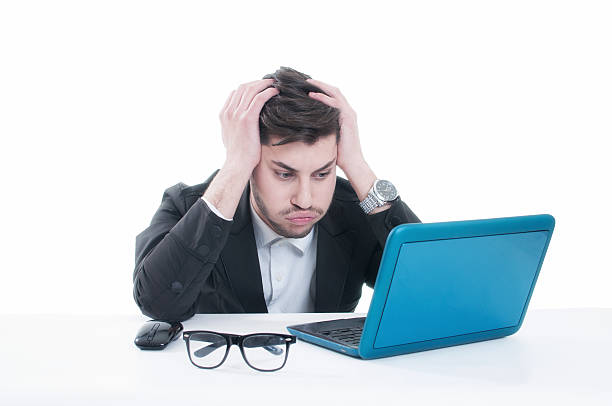 istock Young business man looking at his laptop with disappointment 496385088