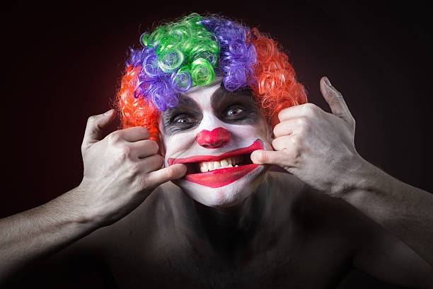 istock Evil Spooky Clown Portrait on dark background. expressive man 496386182